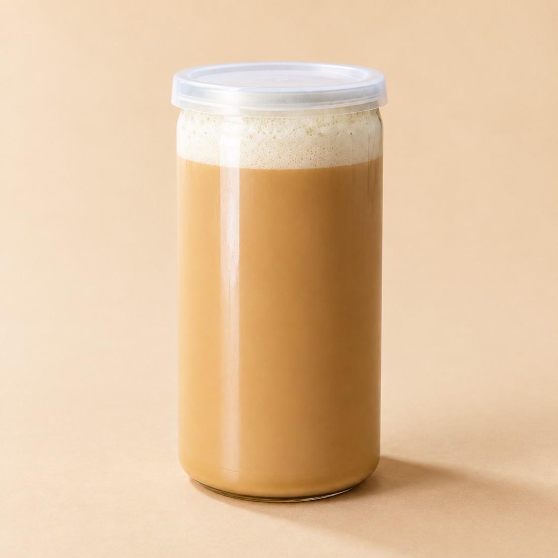 Dark cold brew coffee topped with pale salted vanilla foam in a clear can-style cup