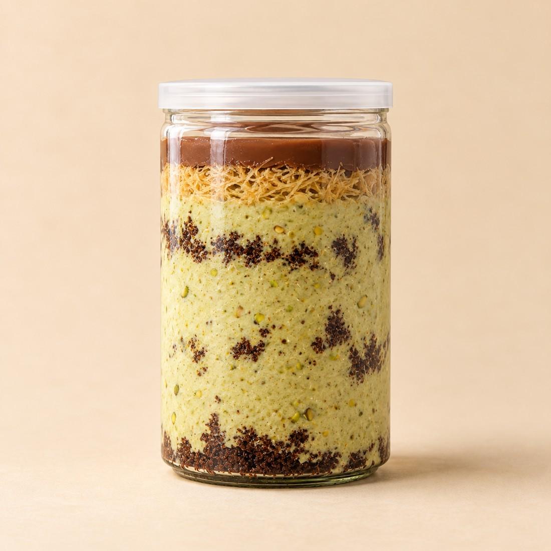Chocolate cake, pistachio mousse and kunafa layered in a clear CRMY dessert jar