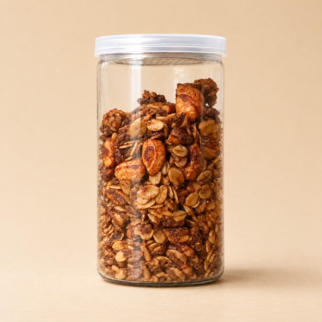 Golden oat and nut granola in a clear CRMY snack jar